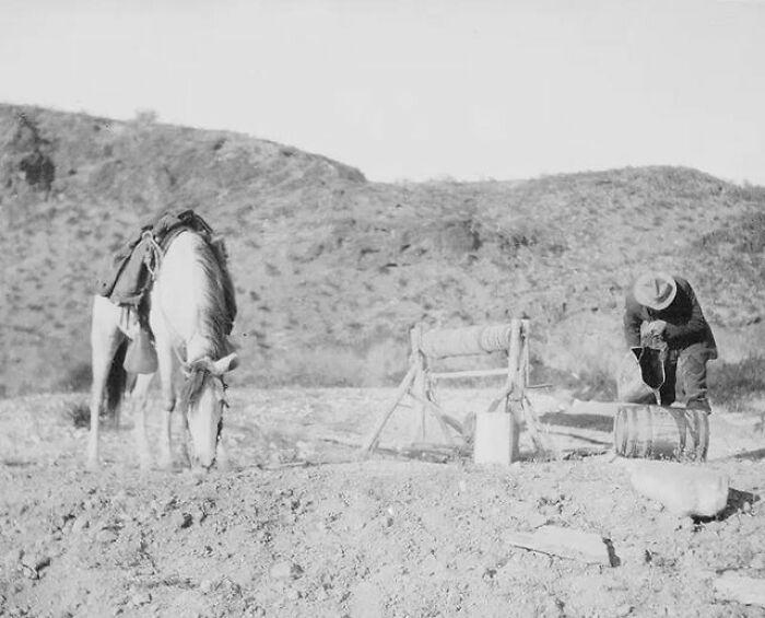 A Rider Fills His Keg From A Desert Well 30 Miles North Of Palomas, Arizona. His Horse Refreshes Himself Nearby. 1907