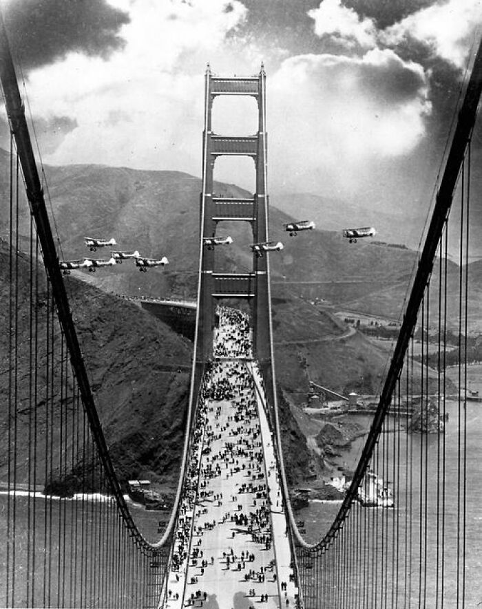 Planes Fly Between The Towers And Pedestrians Cross As A Part Of The Celebration Of The Opening Of The Golden Gate Bridge In May Of 1937