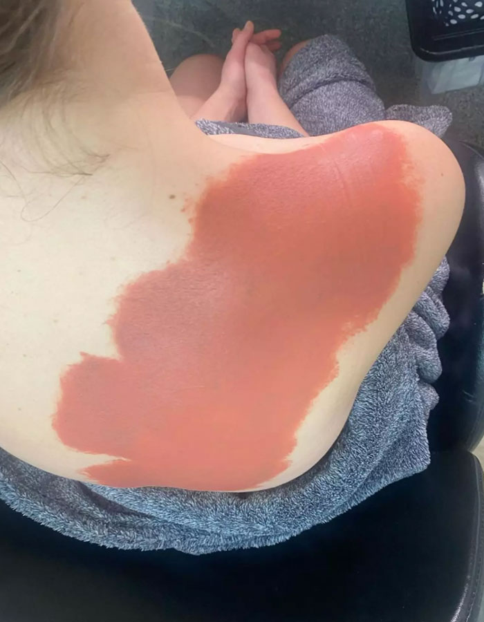 Makeup artist covers large tattoo on Claudia Jessie&rsquo;s shoulder with skin-toned product.