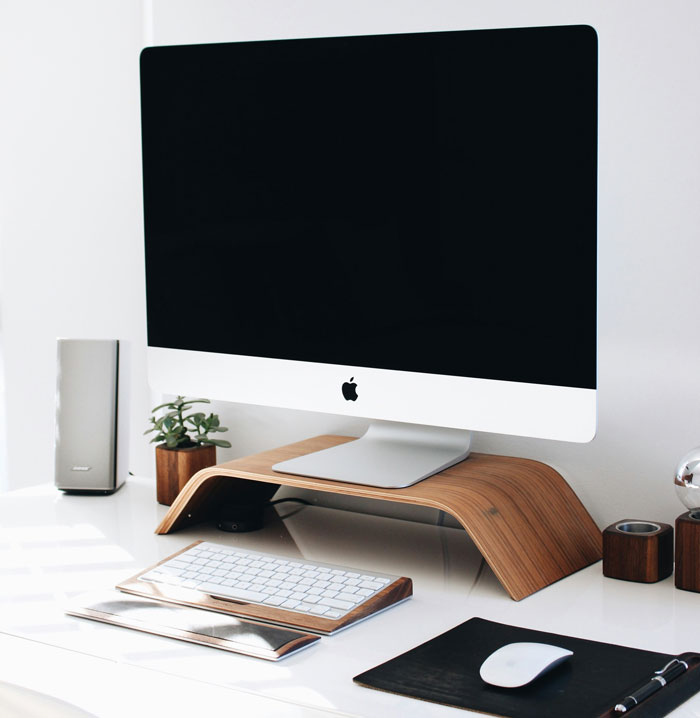 Modern Apple computer setup on a clean desk, illustrating common computer understanding challenges encountered by users.