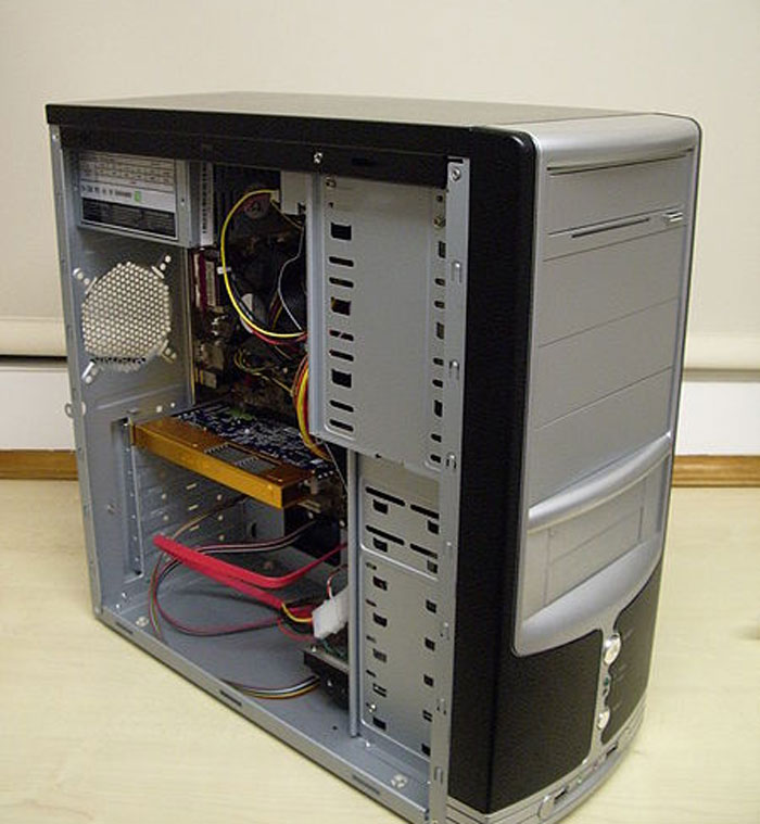 Desktop computer case open showing internal components and cables, illustrating embarrassing attempts at understanding computers.