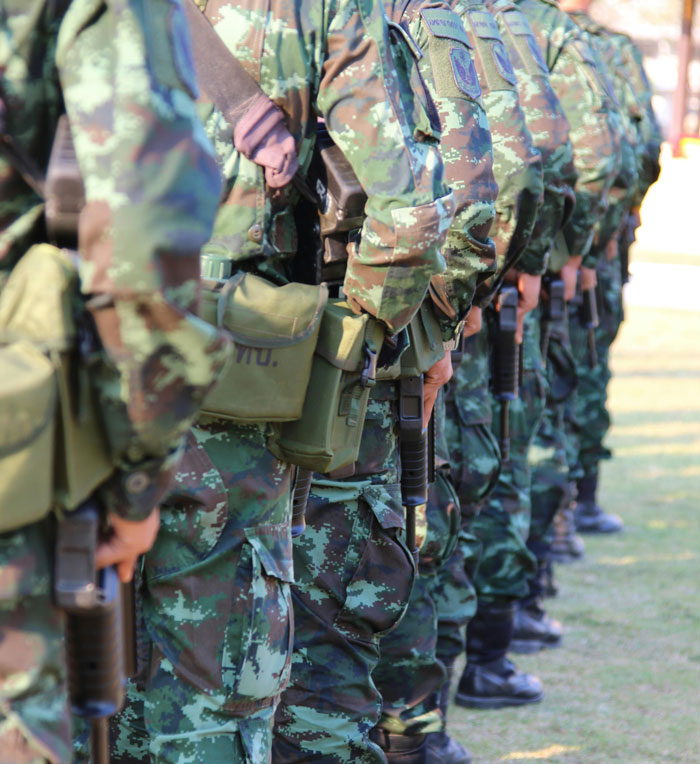 Soldiers standing in a line holding rifles, wearing camouflage uniforms illustrating lifetime supply winnings stories.