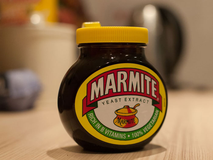 Jar of Marmite yeast extract on table representing lifetime supply winnings stories from wholesome to sad experiences.