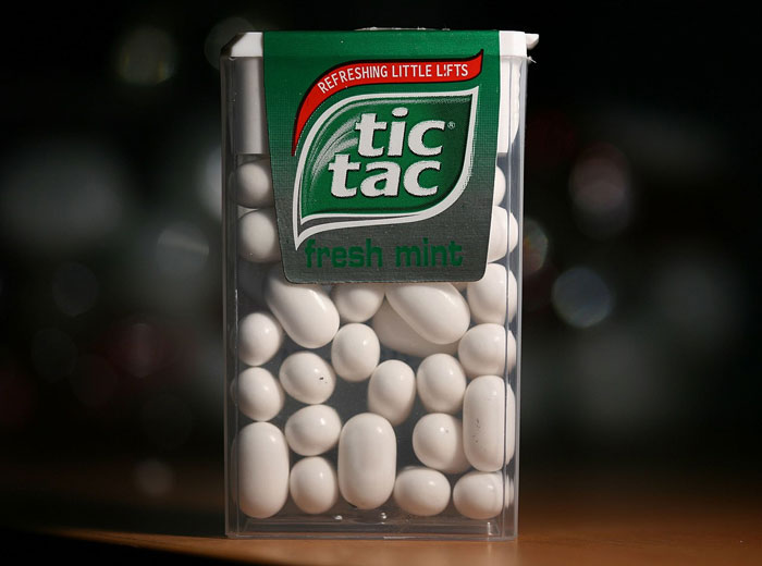 Tic Tac fresh mint container filled with white mints illustrating lifetime supply winnings concept.