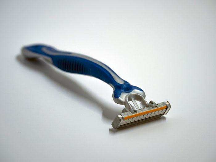 Close-up of a razor on a white surface, representing lifetime supply winnings in personal care products.