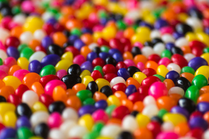 Colorful jelly beans in a close-up view representing lifetime supply winnings in sweet treats and snacks stories.