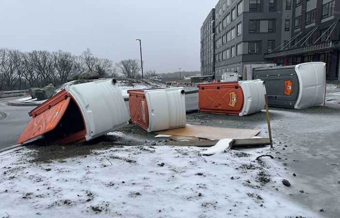A Snowy, Windy Day In New England Blows Over The Toilets On The Job Site