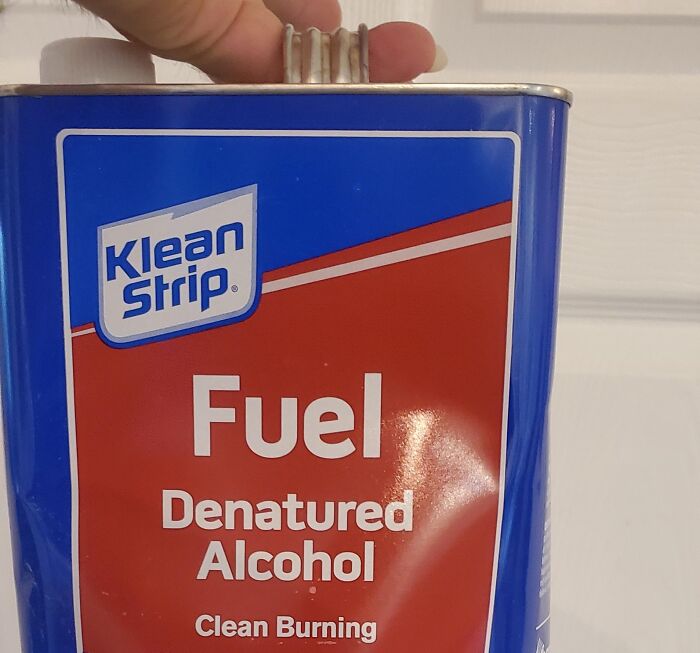 Klean Strip denatured alcohol fuel can held by hand, demonstrating useful life hacks for practical uses.