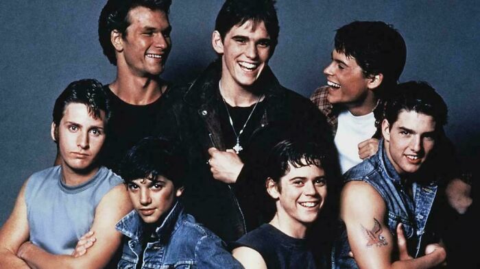 Group of young men smiling together, evoking nostalgia and reminding viewers of creaking joints in a fun way.
