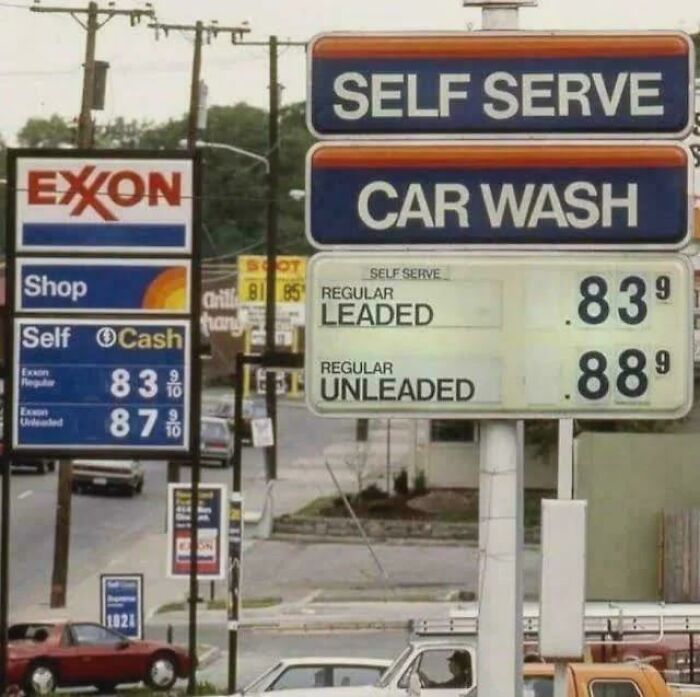 Old gas station price signs showing self-serve car wash and cheap fuel, reminding you of creaking joints nostalgia.