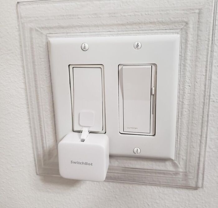 Smart home gadget SwitchBot attached to a light switch showcasing innovative Amazon tech finds for convenience.