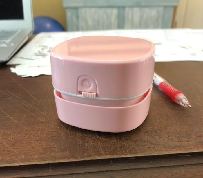 Compact pink gadget on a wooden table, one of the top Amazon tech finds sparking gadget senses and interest.