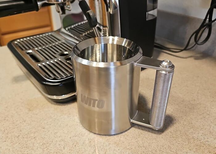 April Fools prank mug with exaggerated size on kitchen counter near coffee machine.