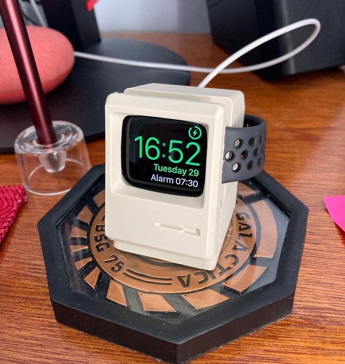 Retro-style Apple Watch charging stand on wooden desk, showcasing popular Amazon tech finds and gadget accessories.