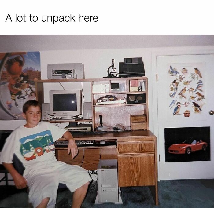 Teen sitting next to vintage computer setup with CRT monitor and VHS tapes, evoking nostalgia for Tamagotchis and VHS era memes.