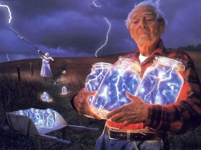 Man holding jars of lightning, wearing a flannel shirt, with dramatic skies in the backdrop; a "Pics That Go Hard" moment.