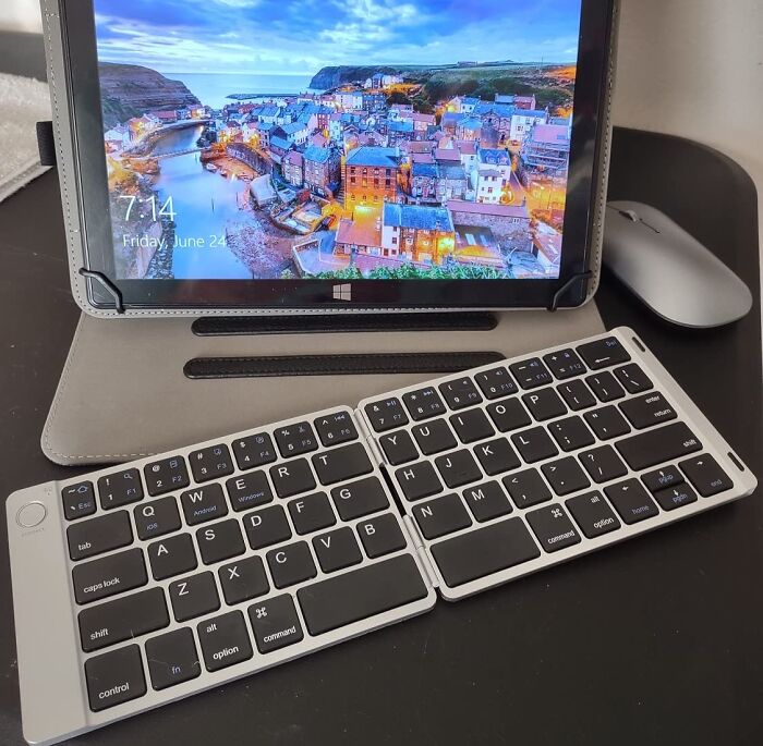 Folding Bluetooth keyboard, tablet with scenic display, and wireless mouse showcasing popular Amazon tech finds.