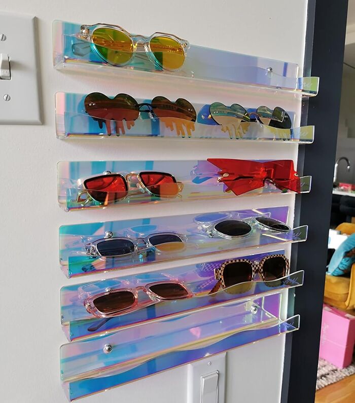 Acrylic shelves holding a collection of sunglasses display, bringing joy with vibrant colors.