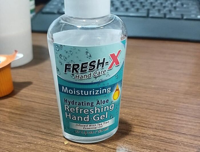 Bottle of Fresh-X moisturizing hand gel on a wooden desk, suitable for family-friendly April Fools pranks.