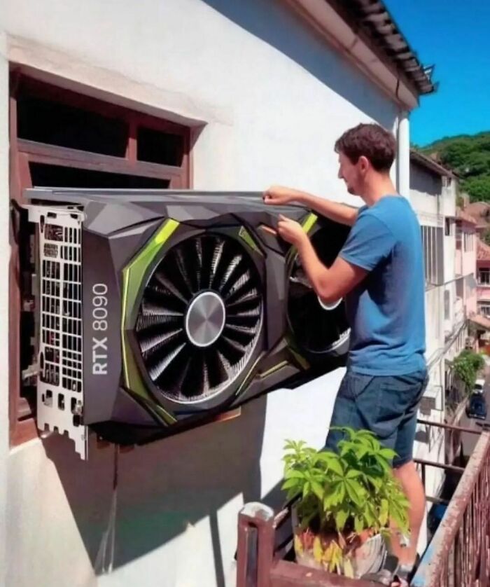 Man installing oversized graphics card on wall, humorous scene from Pics That Go Hard collection.