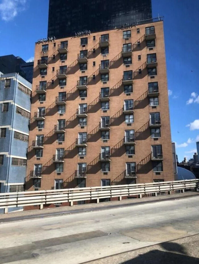 Confusing image of an apartment building with optical illusion from stair shadows creating a puzzling visual effect.