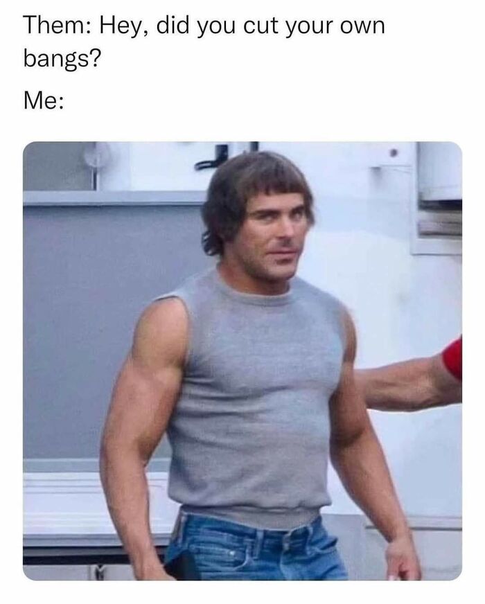 Man with self-cut bangs wearing a sleeveless gray shirt, featured in a relatable and hilarious meme about cutting own hair.
