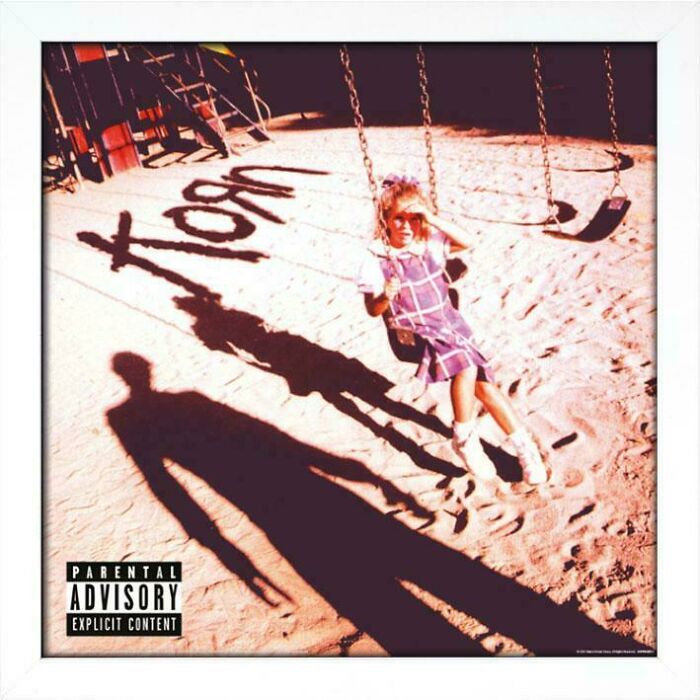 Creepy image of a young girl on a swing set with distorted shadows, including the word "Korn." Hair of kids, babysit.