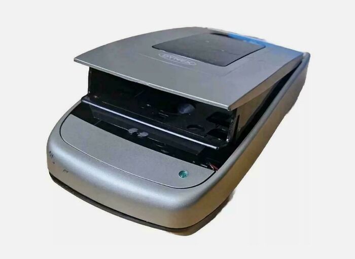 Old flatbed scanner from early 2000s technology as a nostalgic item that may remind you of your creaking joints.