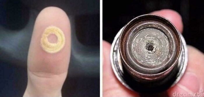 Close-up of a fingertip with a small ring and a matching ring-shaped object, evoking creaking joints nostalgia.