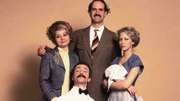 Cast of classic TV show Fawlty Towers posing together, a nostalgic reminder of creaking joints and aging memories.