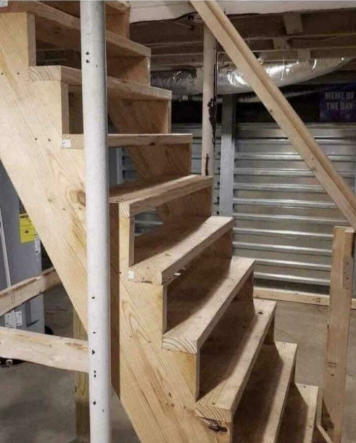 Uneven DIY stairs with misaligned steps creating a dangerous and unstable design in a home improvement disaster.