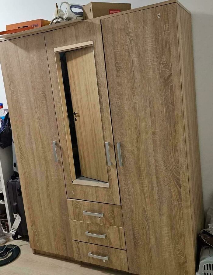 Confusing wardrobe design with a door blending into the pattern, requiring a double take.