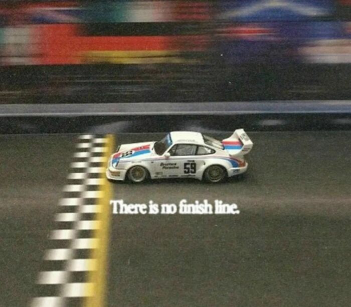 Race car crossing finish line with "There is no finish line" text, capturing a wild and wholesome '90s moment.