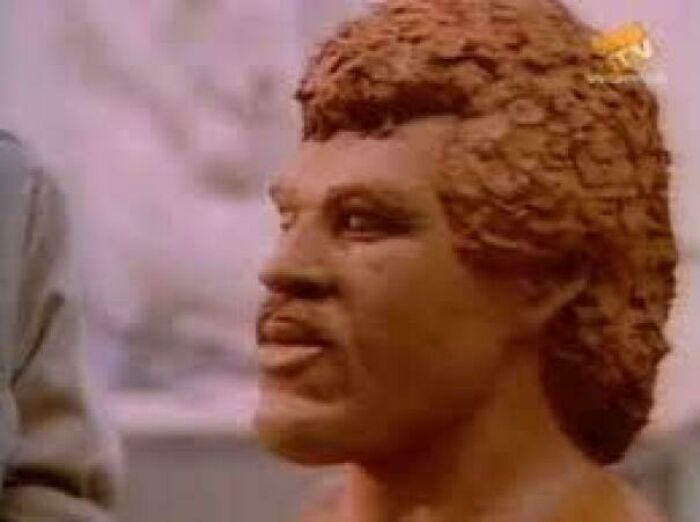 Sculpted bust of a man with curly hair, showcasing a retro style that may remind you of creaking joints nostalgia.