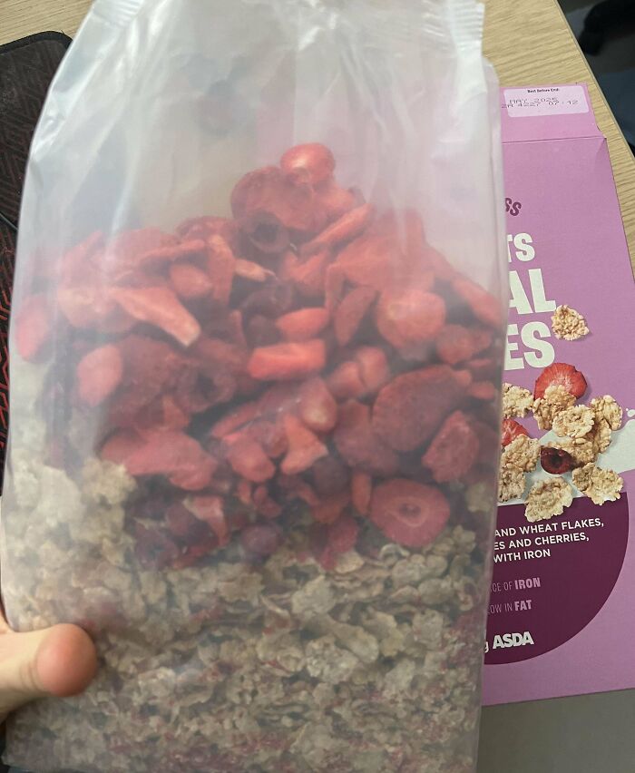 Cereal box with an unusually large amount of dried strawberries, showcasing a humorous British packaging quirk.