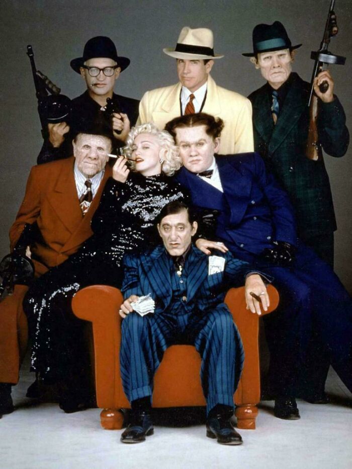 Vintage styled group portrait showing people dressed as gangsters and iconic 1940s characters, nostalgic items reminder.