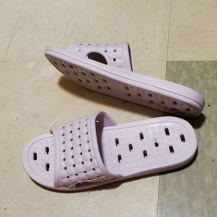 Light purple ventilated slide sandals on tiled floor, a practical dorm find to survive freshman year comfort and convenience.