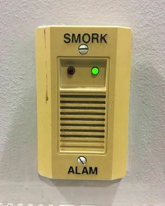 Old yellowed wall alarm device with misspelled words smork and alam, part of very random pics to bring joy collection
