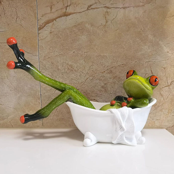 Frog figurine lounging in a bathtub, a show-stopping decor piece.