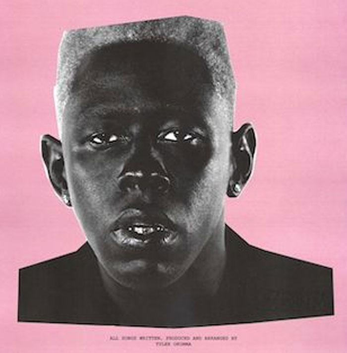 Stylized black-and-white portrait of Tyler The Creator against a pink backdrop, resembling a mugshot on an album cover.