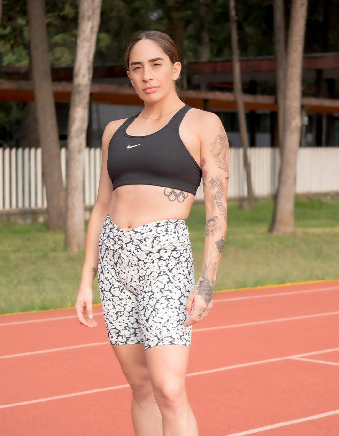 Athlete with tattoos on a running track, symbolizing Paris Paralympics controversy.