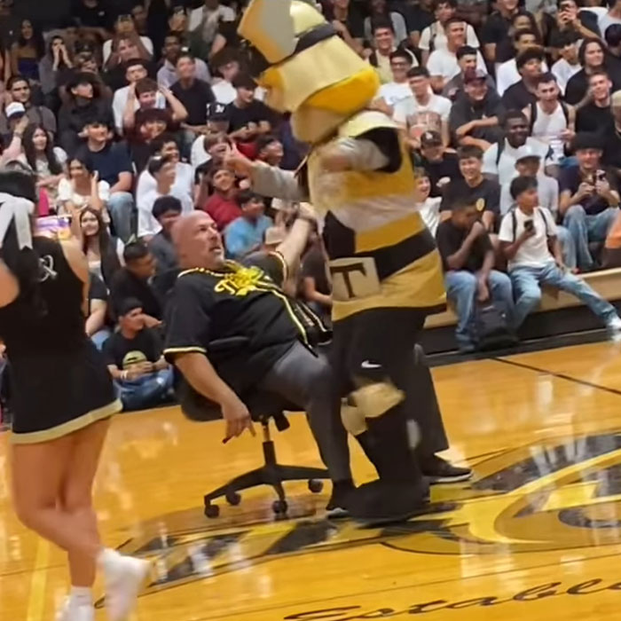 School Principal Placed On Leave After Dancing With Mascot, One Father Says "It Was All Weird" School Principal Placed On Leave After Dancing With Mascot, One Father Says "It Was All Weird"