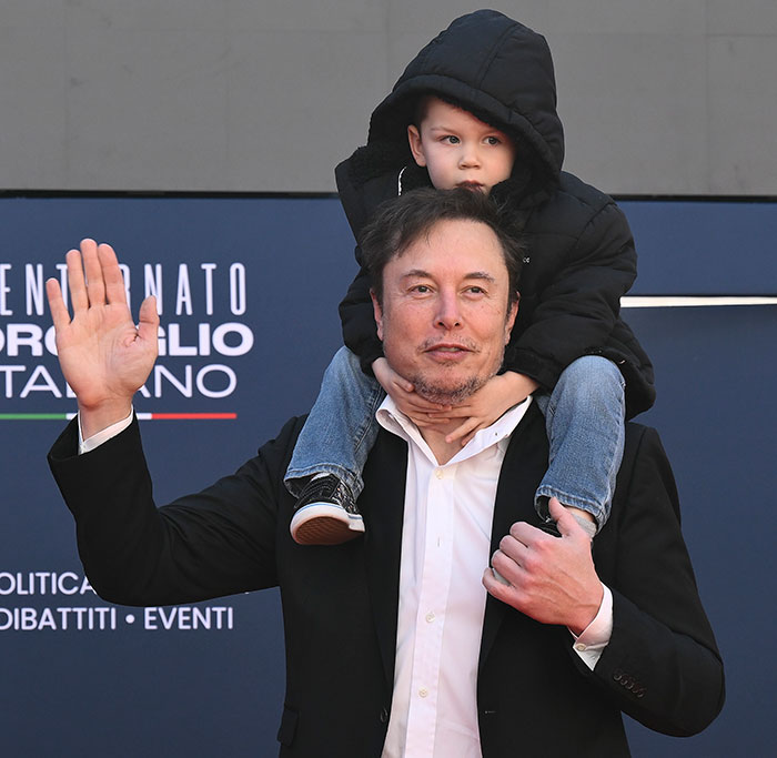 Elon Musk with child on shoulders at an event, legal battle over kids in the background.