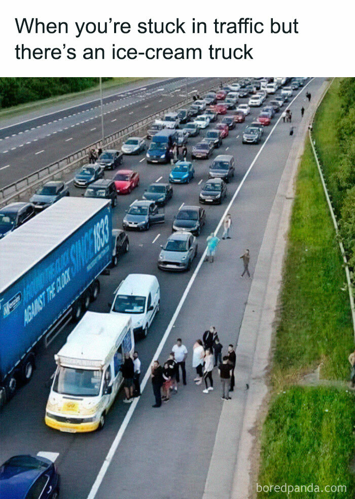 People happily gathering around an ice-cream truck on a busy highway during a traffic jam wholesome memes scene