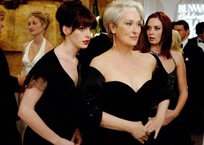 Scene from a surprising film adaptation showing three women dressed elegantly at a formal event, highlighting film adaptations keyword.