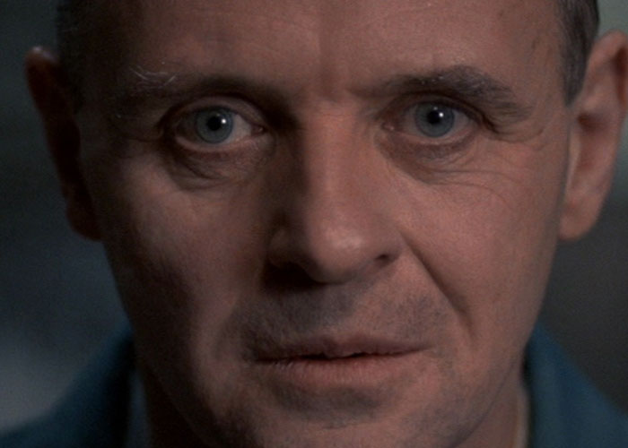 Close-up of an intense man’s face in a film adaptation scene, illustrating surprising film adaptations that outdid their books.