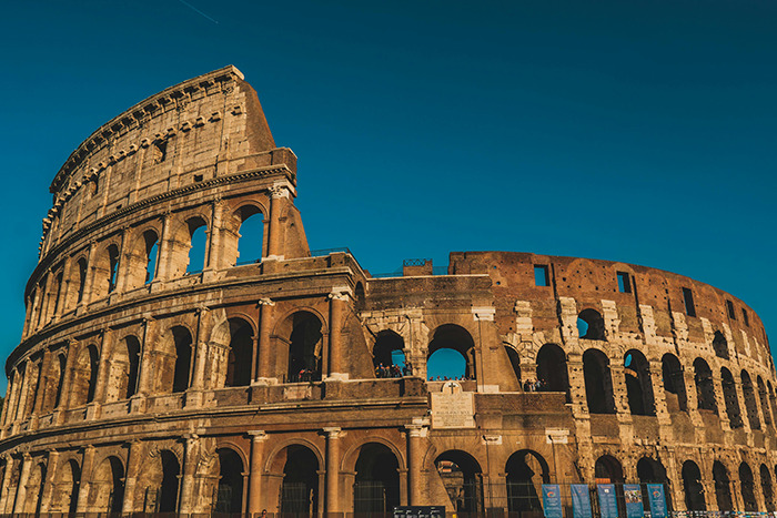 Colosseum in Rome at golden hour, iconic ancient amphitheater and memorable place visited