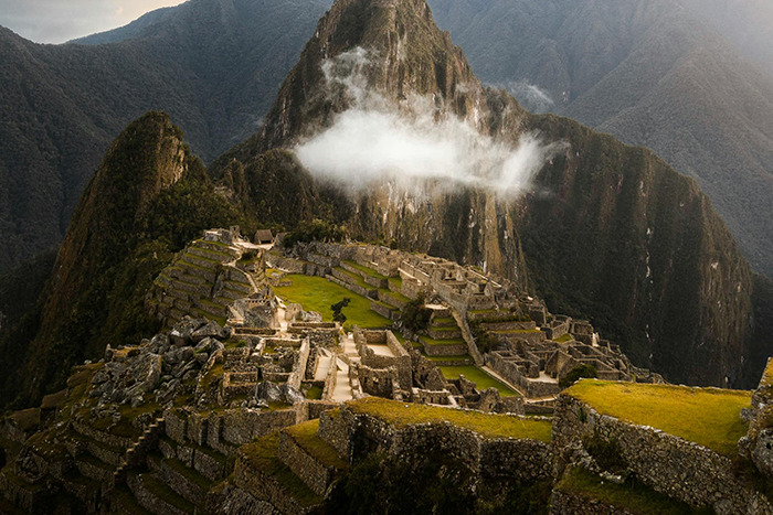 Machu Picchu ruins on misty mountain ridge, a place visited that lived up to the hype for breathtaking views.