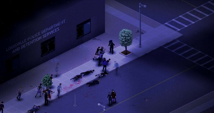 Nighttime scene from a video game showing characters outside a police department with some injured figures on the ground.