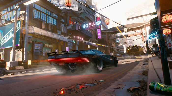Futuristic racing game scene with a sleek car speeding through a neon-lit city street, showcasing gamers’ all-time favorites.